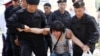 Kazakhstan - Kazakh policemen detain an opposition activist during a rally in Almaty on June 23, 2018. Police have detained dozens of opposition protesters in Kazakhstan's largest city after the exiled nemesis of long-time leader Nursultan Nazarbayev call